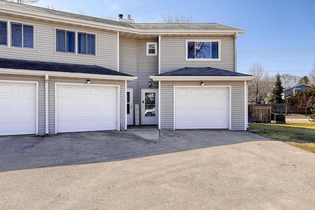 view of front of house featuring a shingled roof and fence