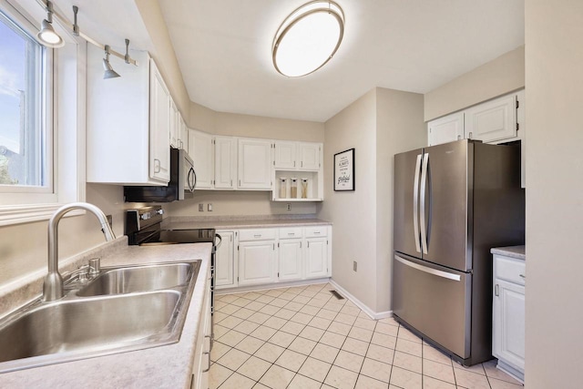 kitchen featuring white cabinets, stainless steel appliances, and a sink