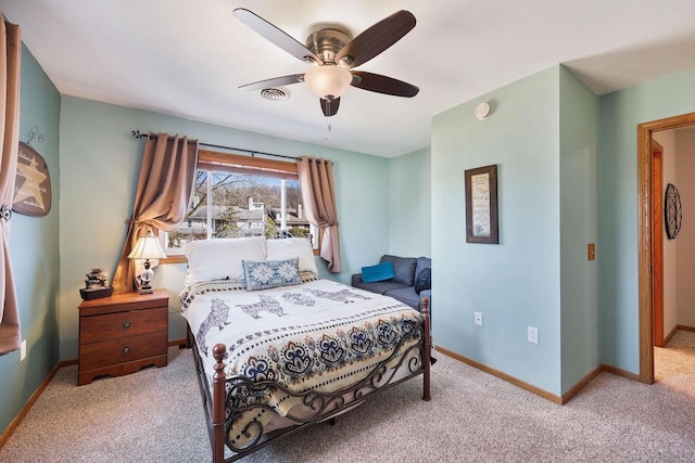 bedroom with ceiling fan, visible vents, baseboards, and light carpet