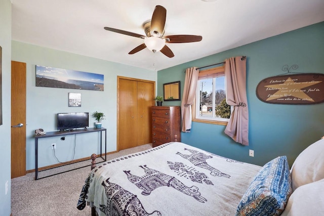 carpeted bedroom featuring a closet, baseboards, and a ceiling fan