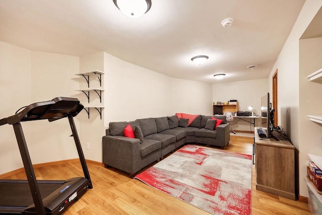 living room featuring baseboards and light wood-type flooring