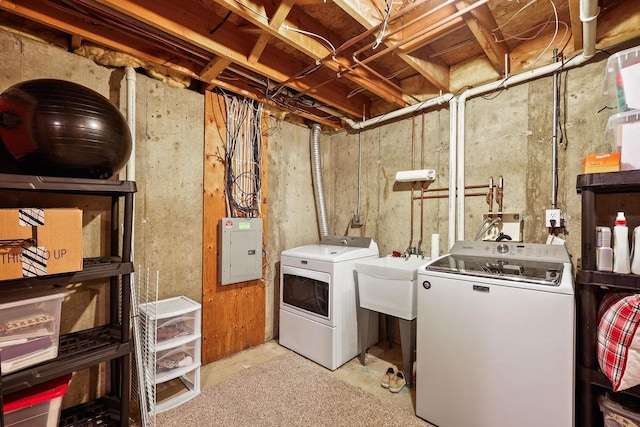 laundry room featuring laundry area, electric panel, separate washer and dryer, and a sink