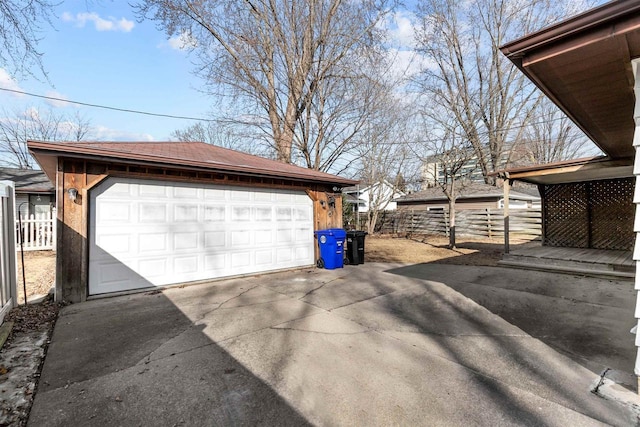 detached garage featuring fence