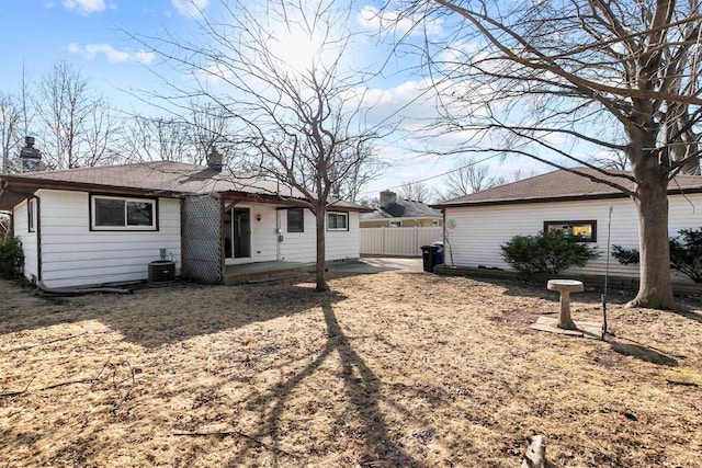 back of property featuring central air condition unit, a patio, a chimney, and fence