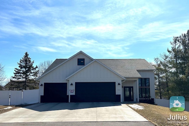 view of front of home featuring a gate, fence, roof with shingles, an attached garage, and concrete driveway