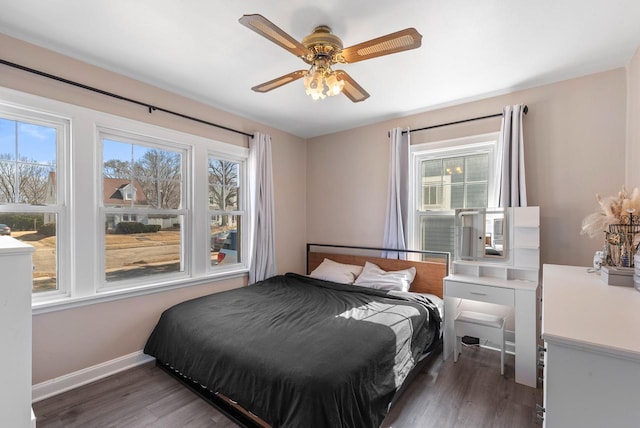 bedroom featuring baseboards, dark wood-style flooring, and ceiling fan