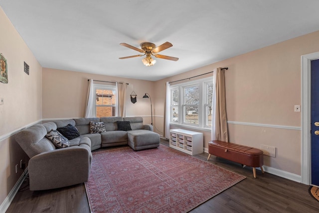 living room featuring a ceiling fan, wood finished floors, and baseboards