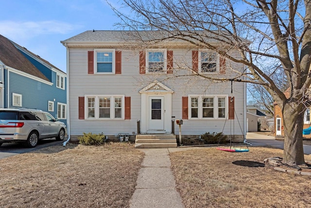 colonial home featuring entry steps