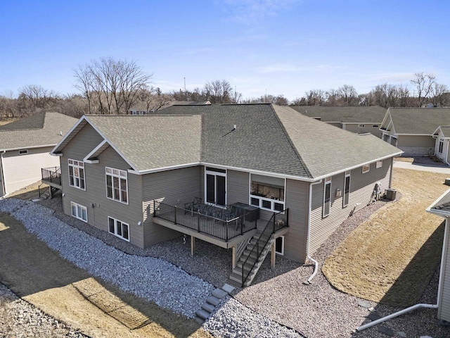 back of house with a wooden deck, a shingled roof, and stairs