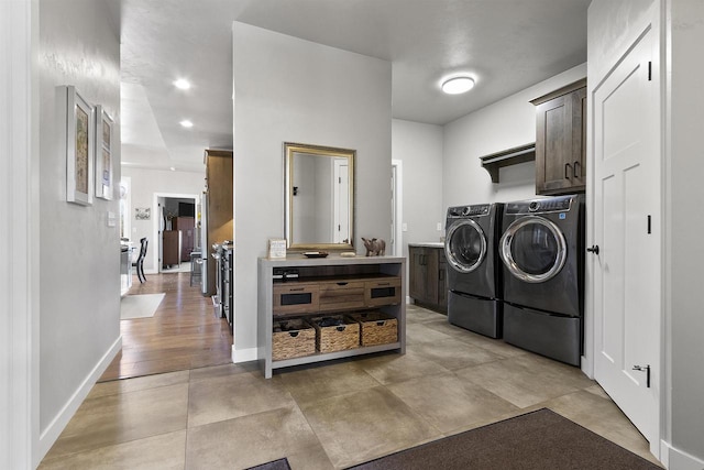 laundry area with washer and dryer, baseboards, cabinet space, and recessed lighting