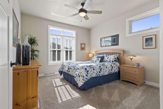 bedroom featuring multiple windows, carpet, visible vents, and baseboards