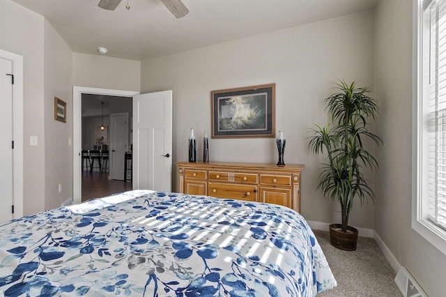 carpeted bedroom with baseboards, visible vents, and ceiling fan