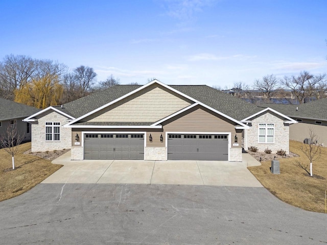 view of front of house featuring concrete driveway, a garage, stone siding, and a shingled roof