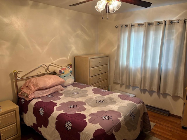 bedroom featuring wood finished floors, visible vents, and ceiling fan