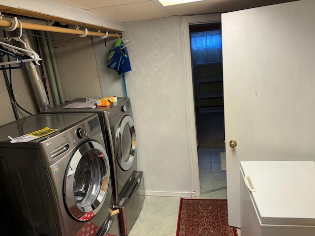 clothes washing area with laundry area and washer and dryer