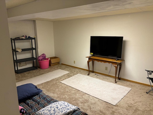 carpeted living room featuring baseboards