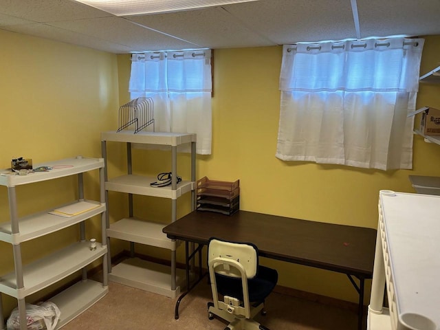 office space featuring a paneled ceiling and baseboards