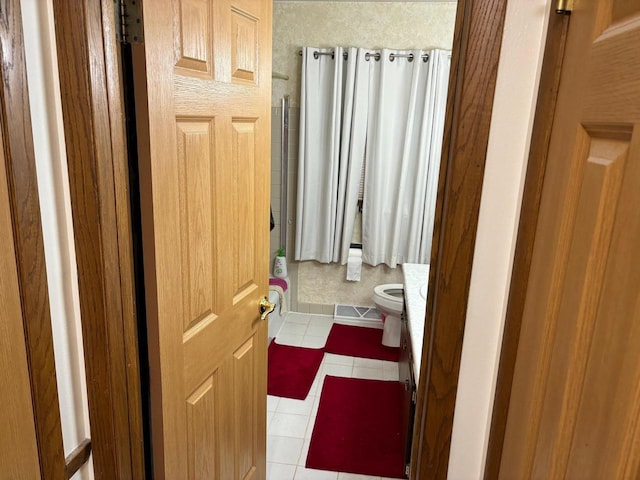 bathroom with tile patterned floors, visible vents, and toilet