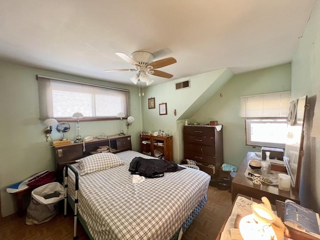 bedroom featuring multiple windows, visible vents, and ceiling fan