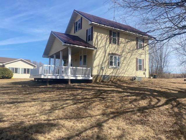 rear view of property with metal roof