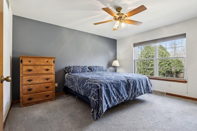 carpeted bedroom featuring a ceiling fan and baseboards