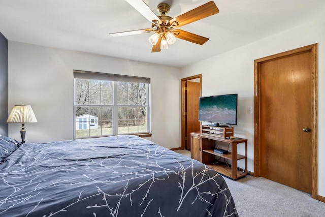 bedroom featuring baseboards, a ceiling fan, and carpet flooring