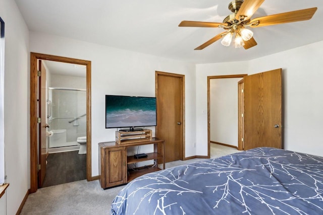 bedroom featuring ceiling fan, ensuite bath, baseboards, and light carpet