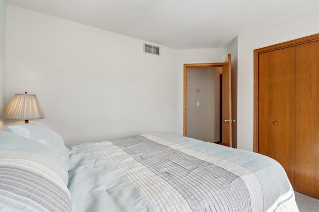 bedroom featuring visible vents and a closet