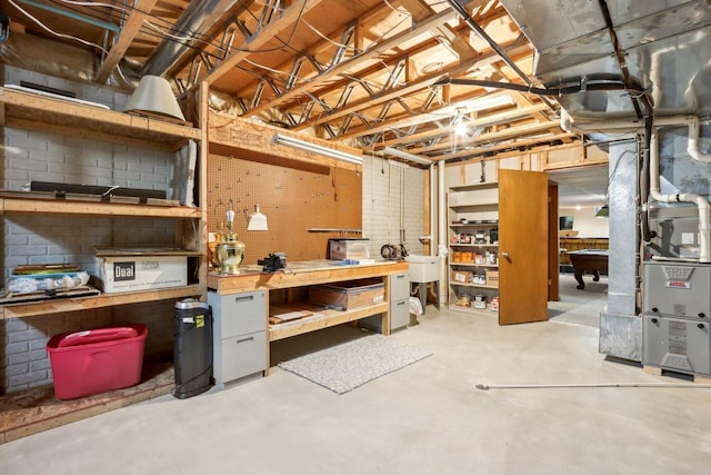 basement with a workshop area and heating unit