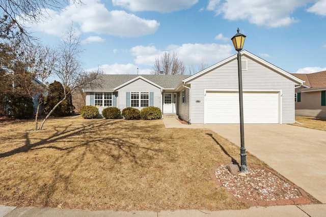 ranch-style home with an attached garage, concrete driveway, and a front lawn