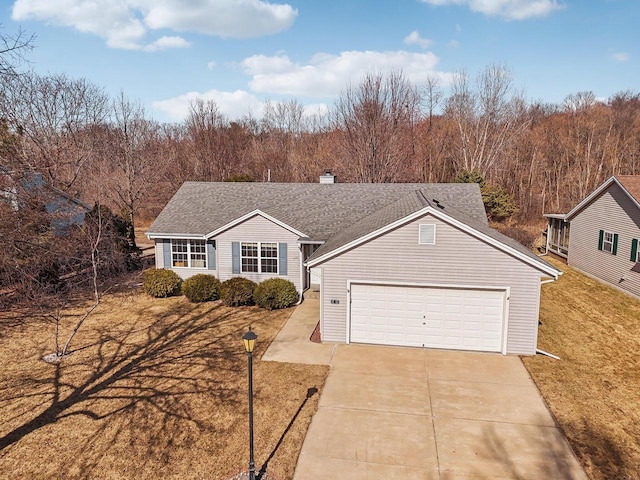 ranch-style home with a front lawn, driveway, roof with shingles, an attached garage, and a chimney