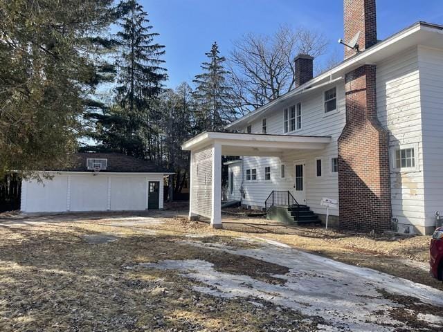 back of house with a chimney