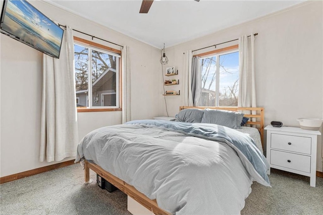 bedroom with baseboards, carpet floors, and ceiling fan