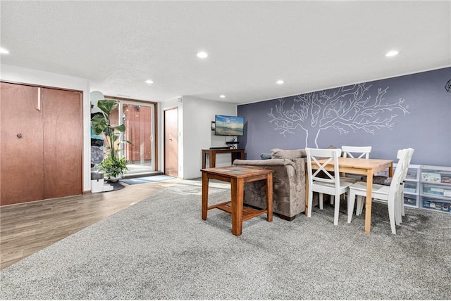 dining area featuring recessed lighting, wallpapered walls, and wood finished floors