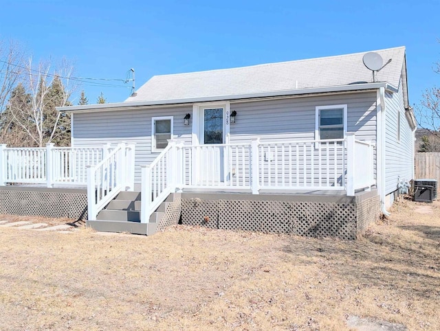 rear view of house with a wooden deck and central AC