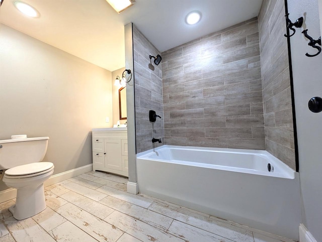 bathroom with baseboards, toilet, recessed lighting, vanity, and  shower combination