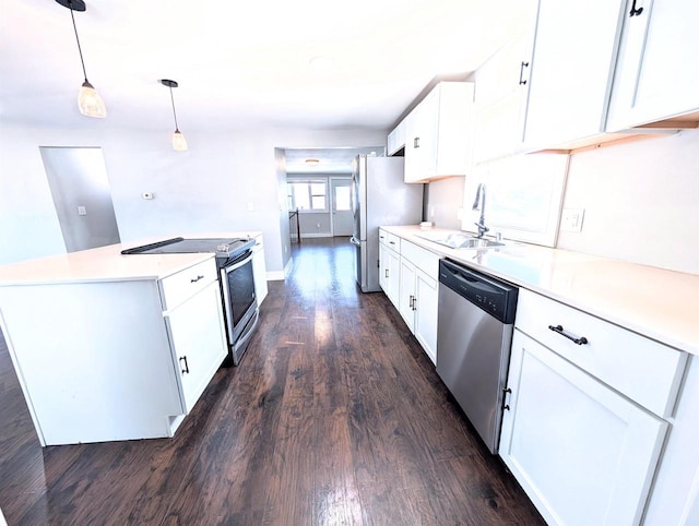 kitchen featuring dark wood-style flooring, a sink, stainless steel appliances, light countertops, and white cabinetry