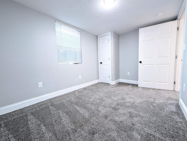 unfurnished bedroom with baseboards and carpet floors