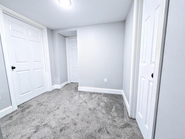 unfurnished bedroom featuring carpet flooring and baseboards