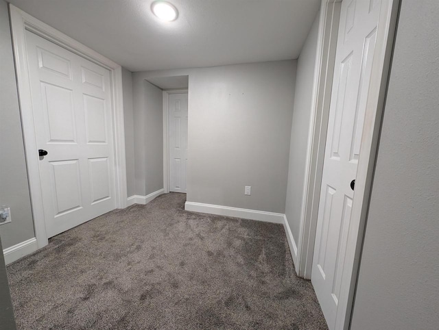 unfurnished bedroom featuring carpet flooring and baseboards