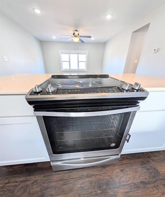 details featuring stainless steel electric range oven, wood finished floors, recessed lighting, ceiling fan, and light countertops