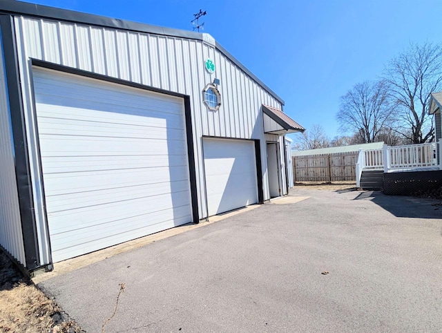 detached garage featuring fence