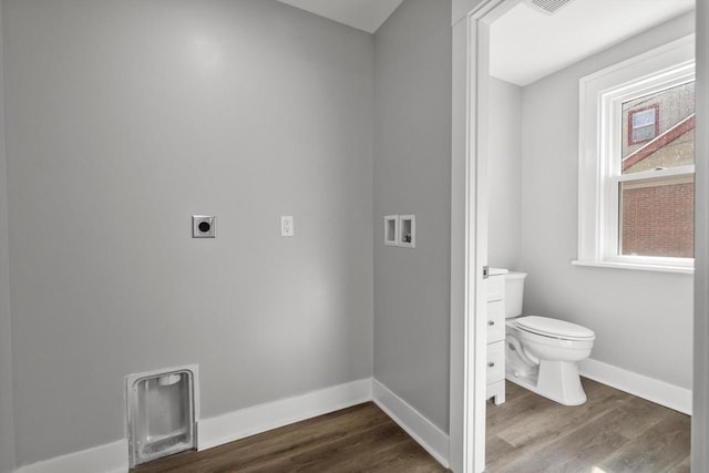 interior space featuring washer hookup, dark wood-type flooring, baseboards, and electric dryer hookup