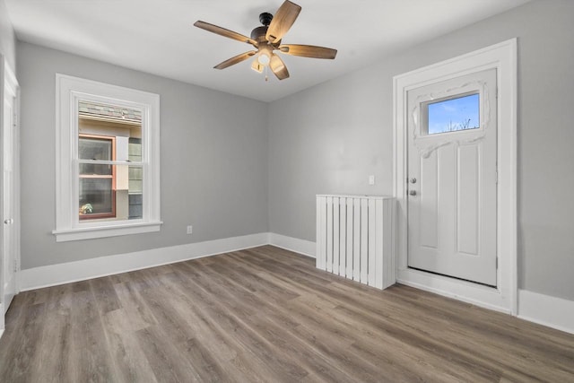 entrance foyer with ceiling fan, baseboards, and wood finished floors