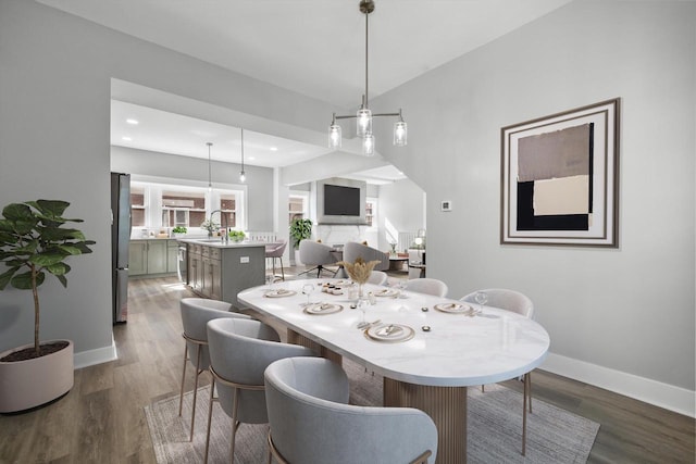 dining area featuring recessed lighting, baseboards, and wood finished floors