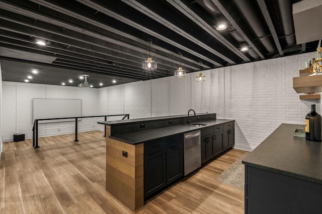 kitchen with open shelves, stainless steel dishwasher, dark countertops, and light wood finished floors