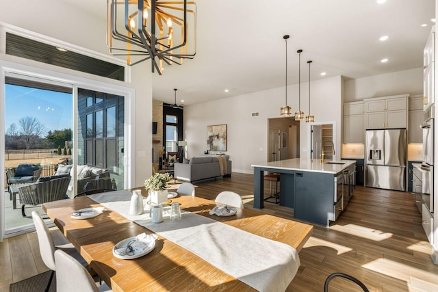 dining area featuring dark wood finished floors, a chandelier, recessed lighting, and visible vents