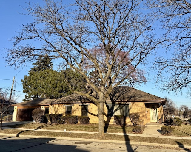 view of front of property featuring a garage and brick siding