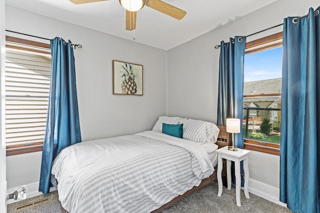 bedroom featuring ceiling fan, carpet, and baseboards