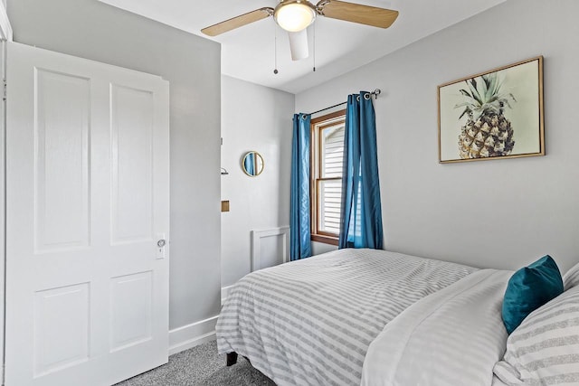 bedroom with a ceiling fan, baseboards, and carpet floors